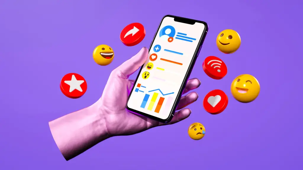 Main tenant un téléphone avec réactions et émojis de médias sociaux